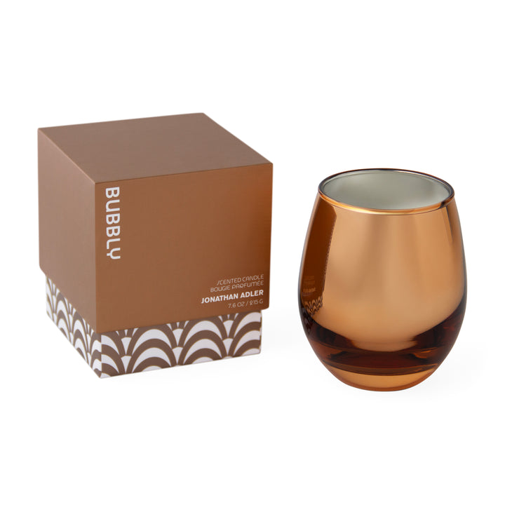 Jonathan Adler Duftkerze Pop Bubbly im bronzefarbenen Glas neben der bedruckten Geschenkbox